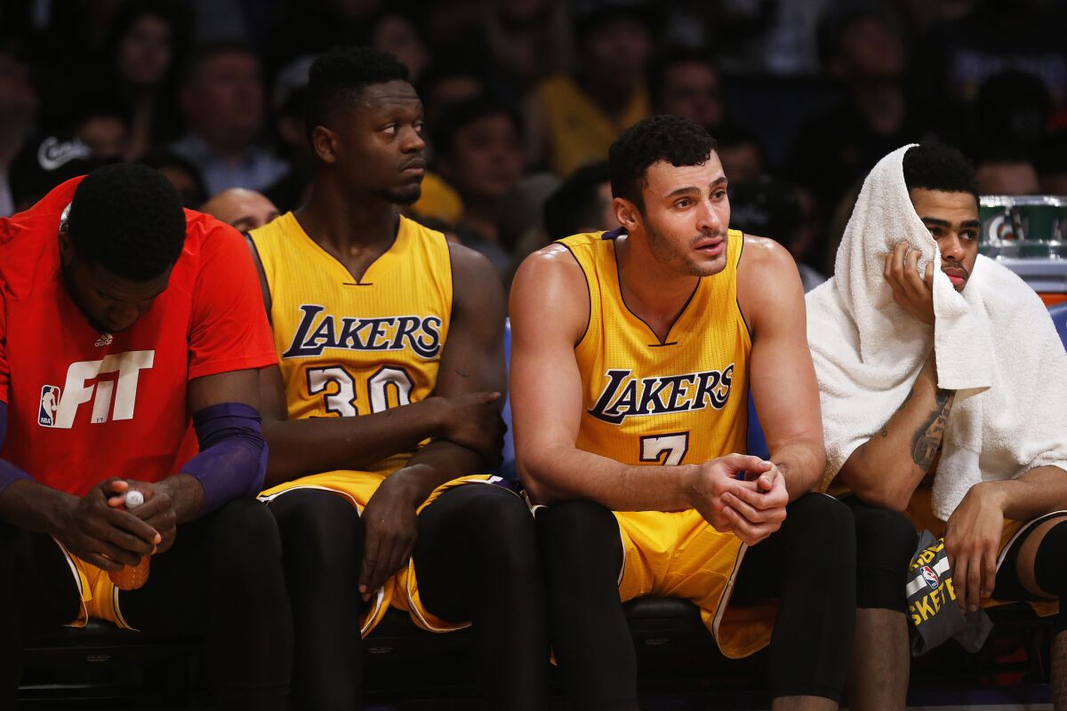 The Lakers rookies watch the final moments of a 114-91 loss to the Bulls from the bench.