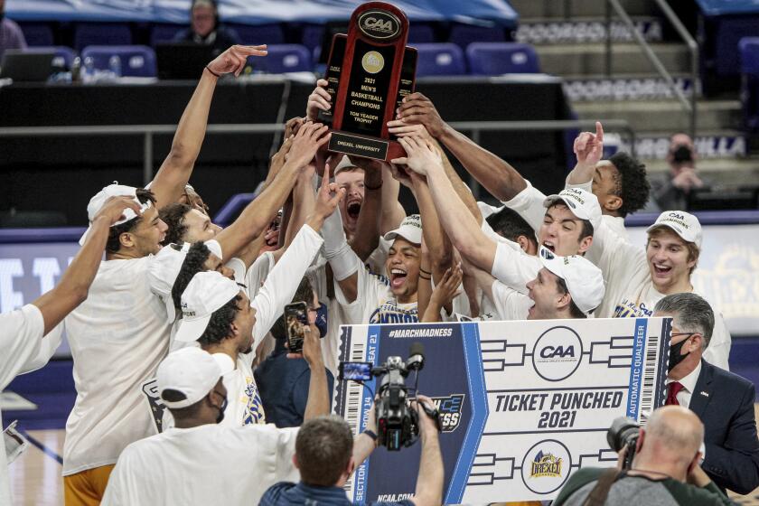 Drexel celebrates after a win over Elon in an NCAA college basketball game for the Colonial Athletic Association men's tournament championship in Harrisonburg, Va., Tuesday, March 9, 2021. (AP Photo/Daniel Lin)