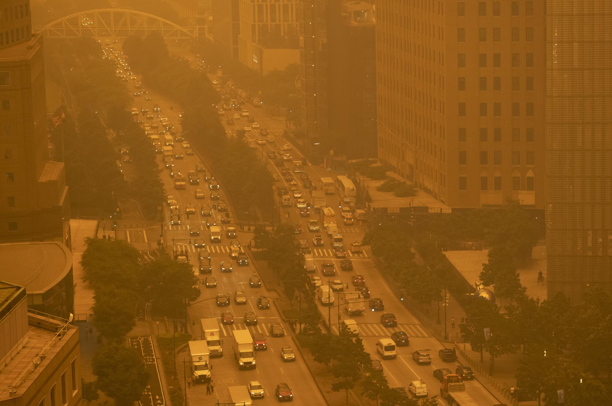 Traffic moves along in New York amid a smoky haze from wildfires in Canada.