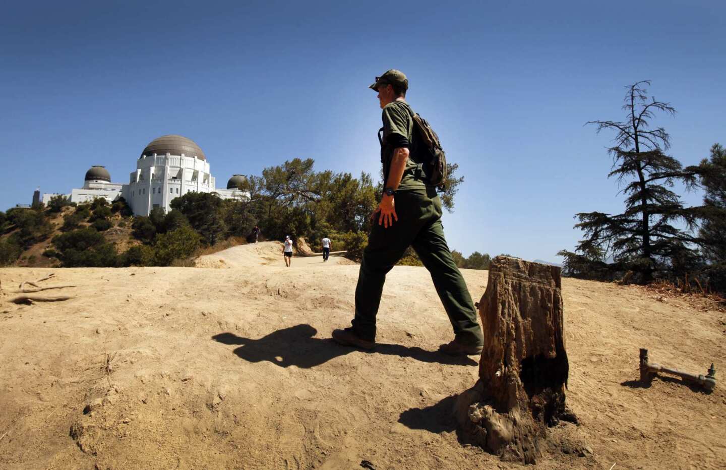 Jeff Sikich, wildlife biologist with the National Park Service, walks a trail in Griffith Park near the observatory to access remote cameras used to monitor possible activity by mountain lion P-22. Sikich and his team captured and radio-collared the lion near Griffith Park on March 28, but the GPS has stopped functioning.