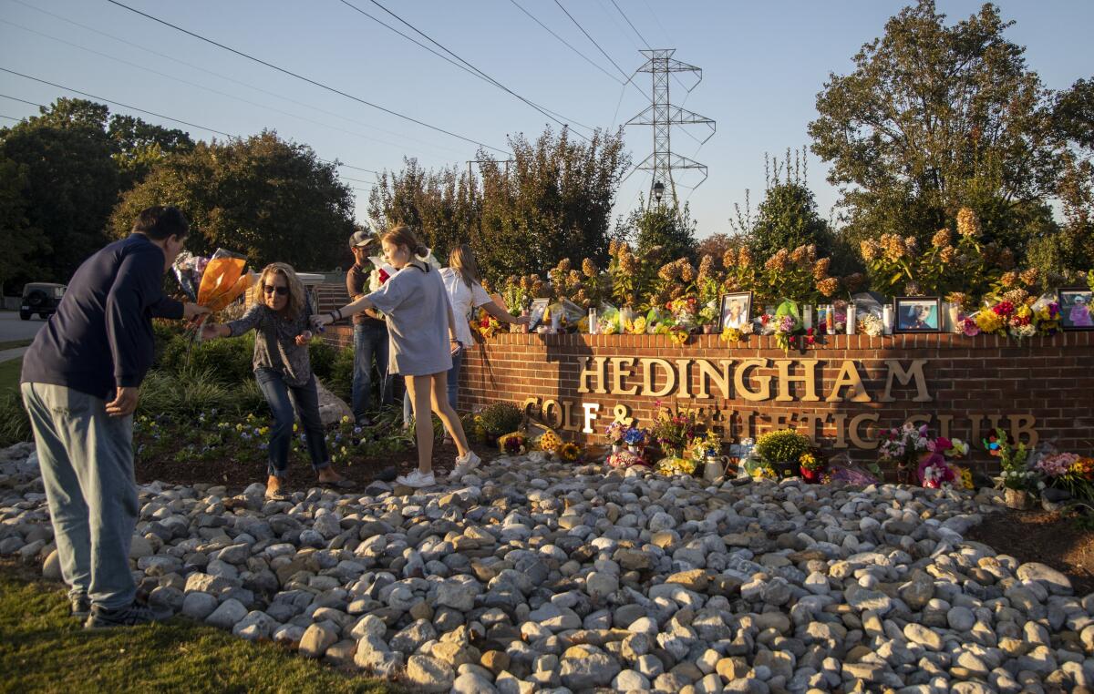 Raleigh's Hedingham neighborhood entrance sign becomes a makeshift memorial Saturday, Oct. 15, 2022, following Thursday's mass shooting in the neighborhood and on the nearby Neuse River greenway trail. (Travis Long/The News & Observer via AP)