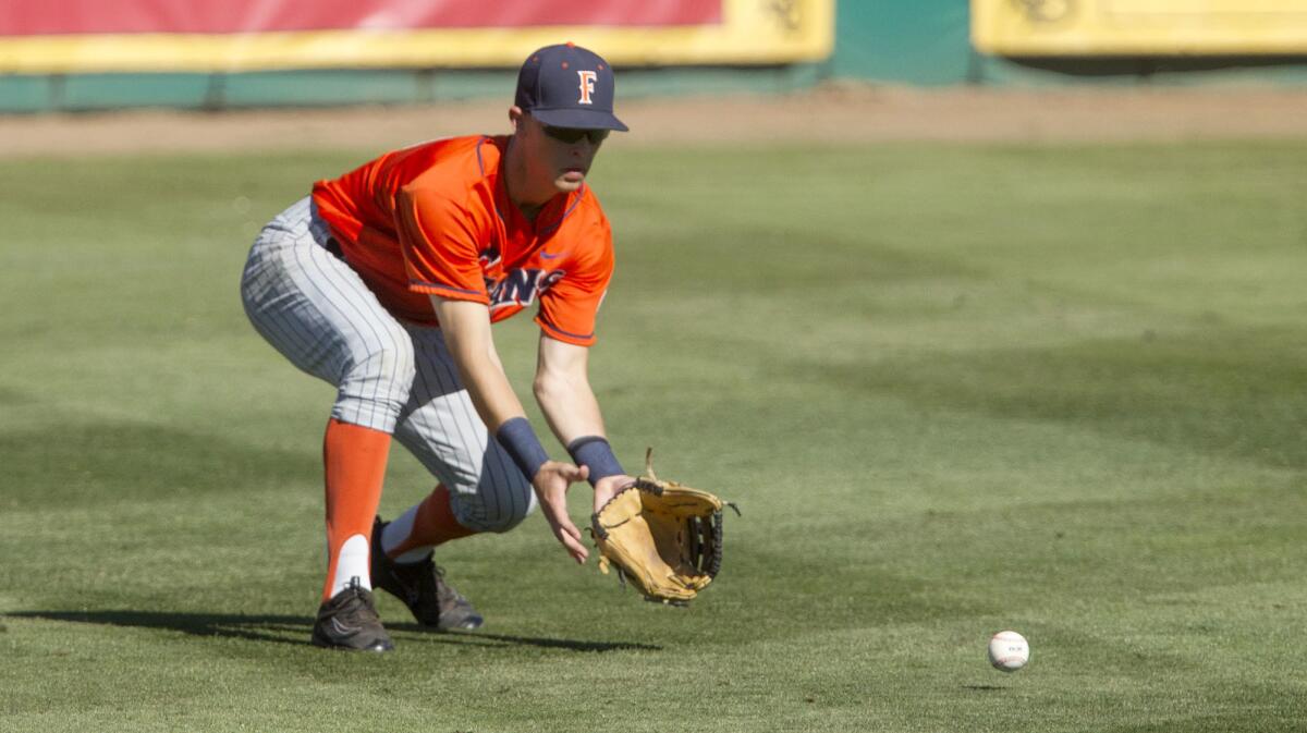 Cal State Fullerton's Chris Prescott collects a ground ball in the fifth inning against Long Beach State during game one of a best-of-three series NCAA Super Regional at Blair Field in Long Beach on Friday. Prescott singled in five at-bats Saturday.