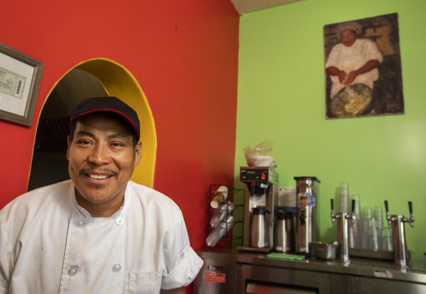 Hector Martinez runs the Oaxacan-style restaurant with his wife and daughter. The painting on the wall is of him.