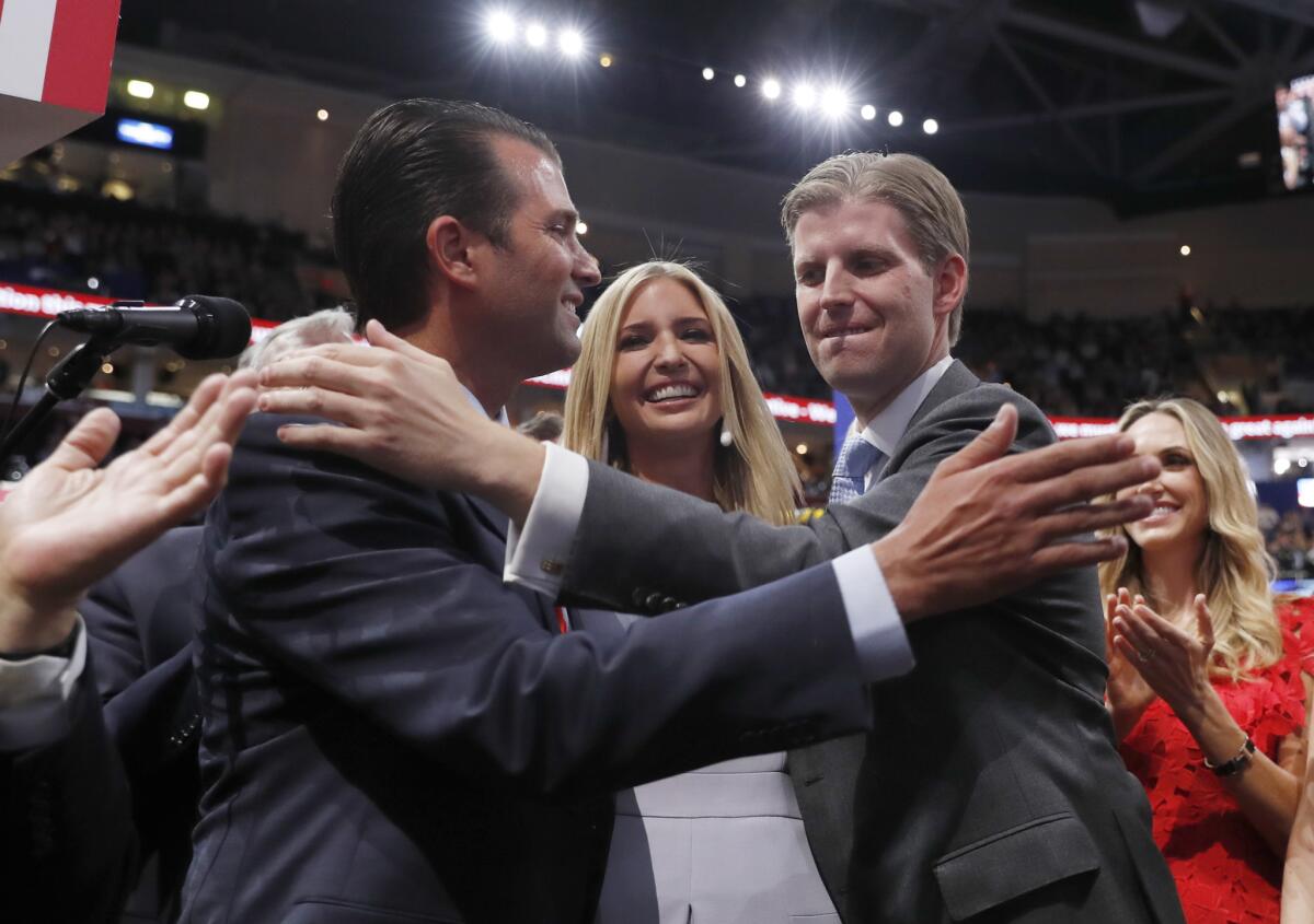 Donald Trump Jr., Ivanka Trump and Eric Trump hug at the 2016 Republican National Convention.