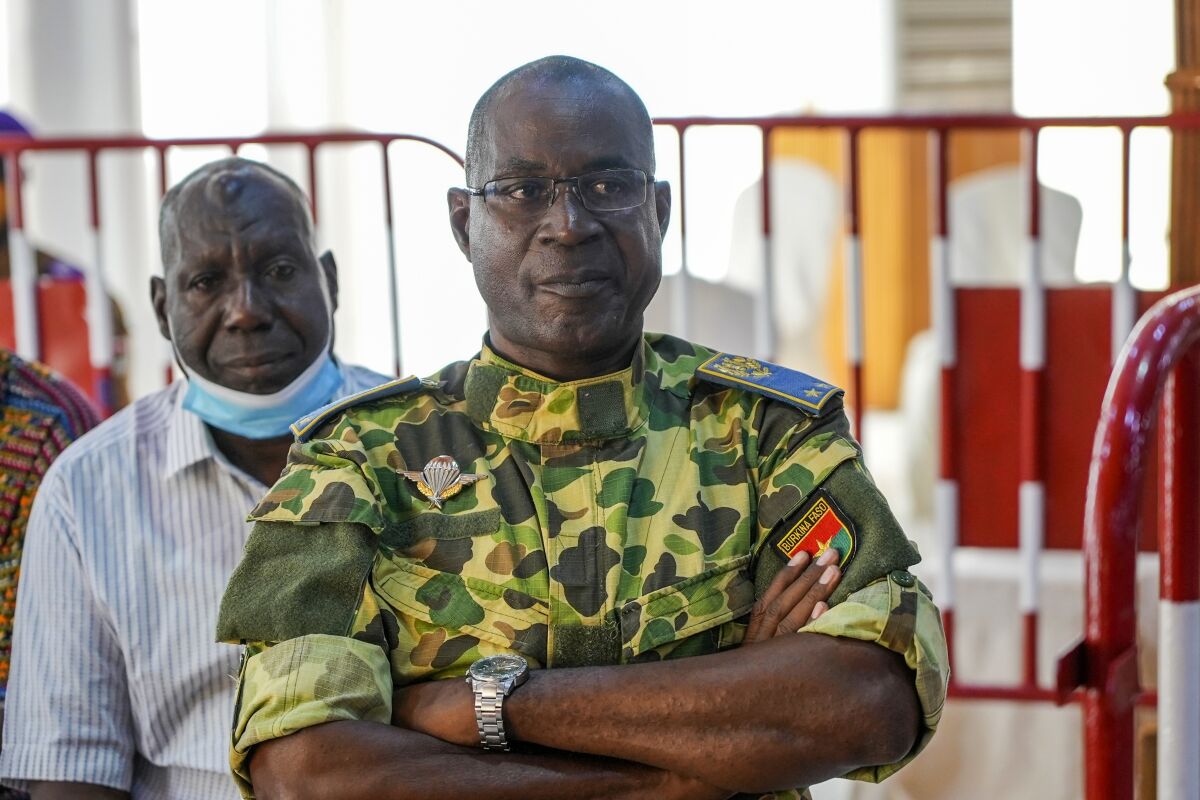 Burkina Faso General Gilbert Diendere sits in a military court where he stands trial with 13 others, including former President Blaise Compaore, charged with the murder of leader Thomas Sankara, in Ougadougou, Burkina Faso, Monday, Oct. 11, 2021. A military court in Burkina Faso has started the trial of 14 people including former President Compaore for the killing of influential leftist leader Thomas Sankara, who was ousted as president by Compaore in a 1987 coup. (AP Photo/Sam Mednick)