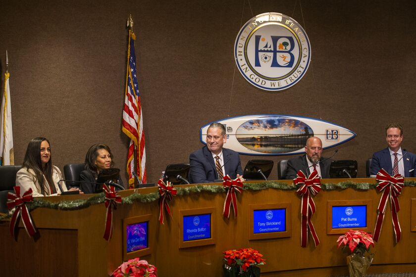 Huntington Beach, CA - December 06: Newly elected members of the Huntington Beach City Council Gracey Van Der Mark, left, Tony Strickland, Pat Burns and Casey McKeon sit on the dais during the swearing in ceremony on Tuesday, Dec. 6, 2022 in Huntington Beach, CA. (Scott Smeltzer / Daily Pilot)