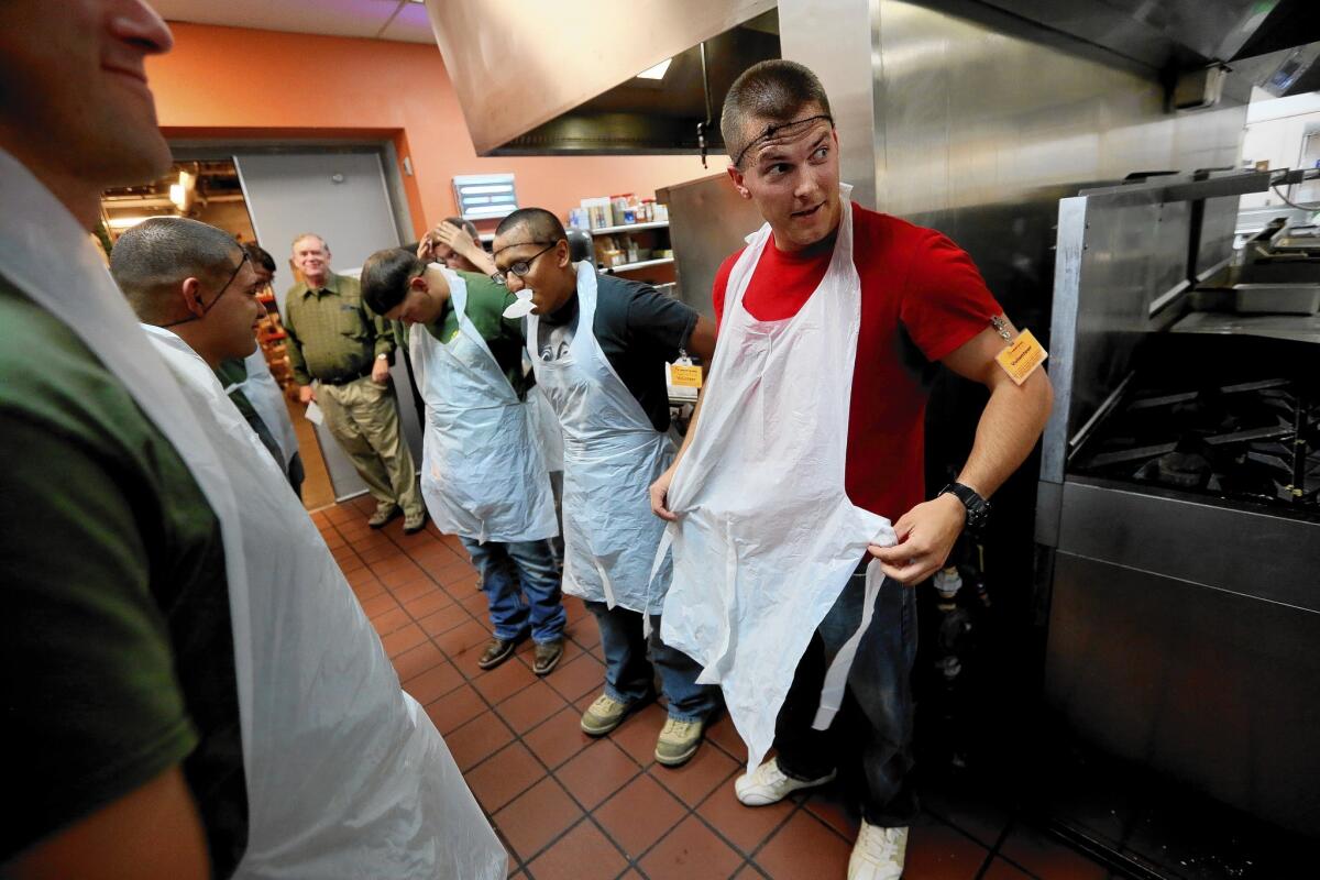 Marines from the base at Twentynine Palms put on hair nets and aprons Sunday before helping to feed breakfast to residents of St. Vincent de Paul Village in San Diego. Of the 900 people or so living at the facility, 167 are veterans.
