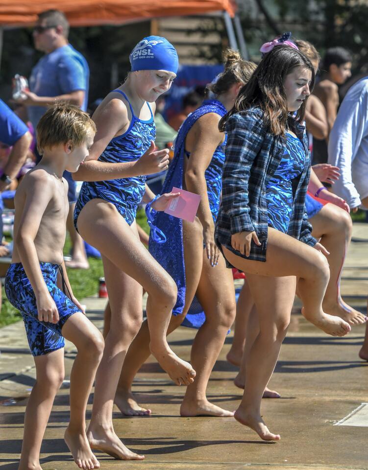 Clemens Crossin swimmers dance on the pool deck during a break in the action of the Columbia Neighborhood Swim League meet between host Clemens Crossing and Harper's Choice Saturday morning in Columbia.