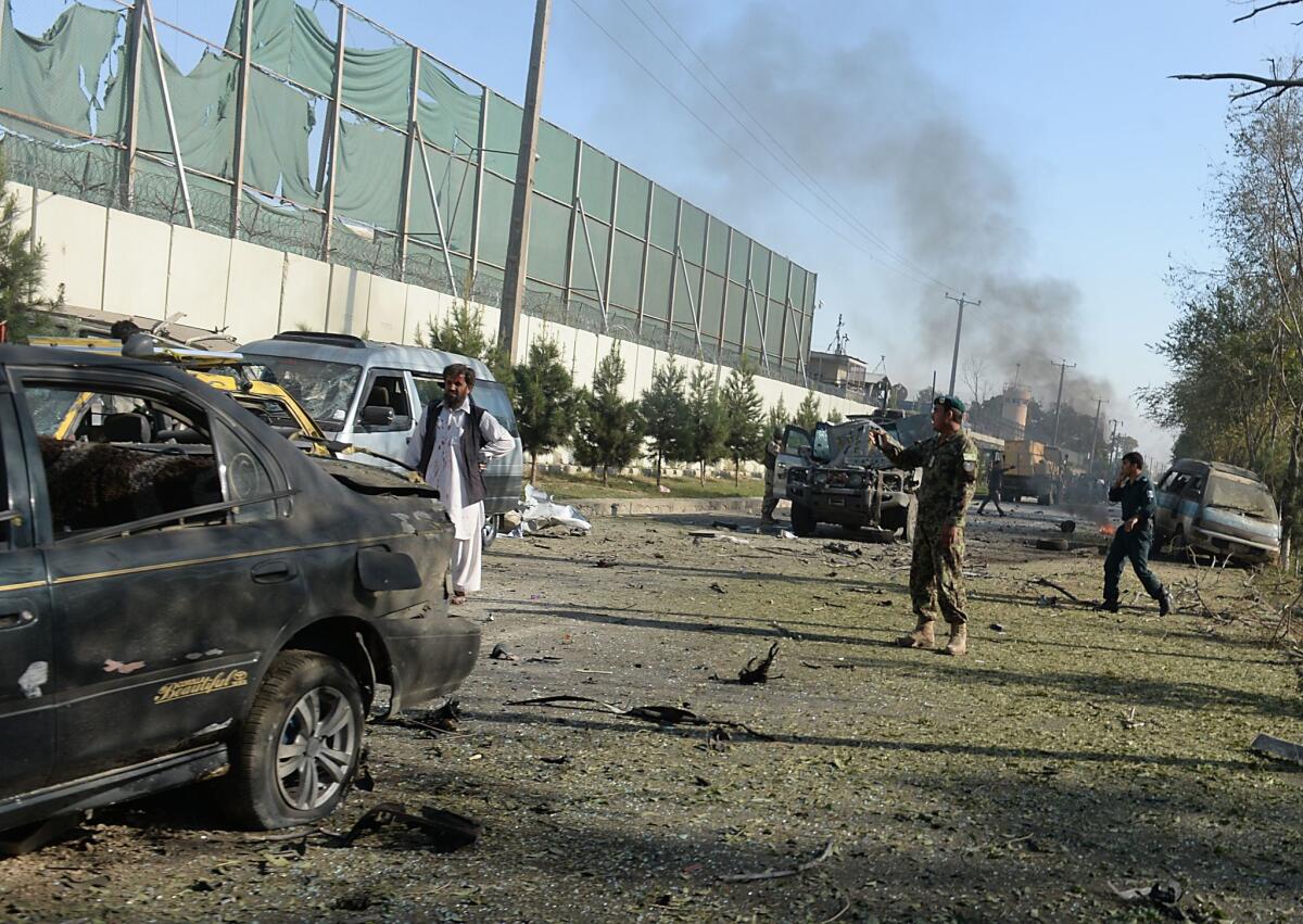 An Afghan soldier stands at the site of a suicide attack in central Kabul on Sept. 16.