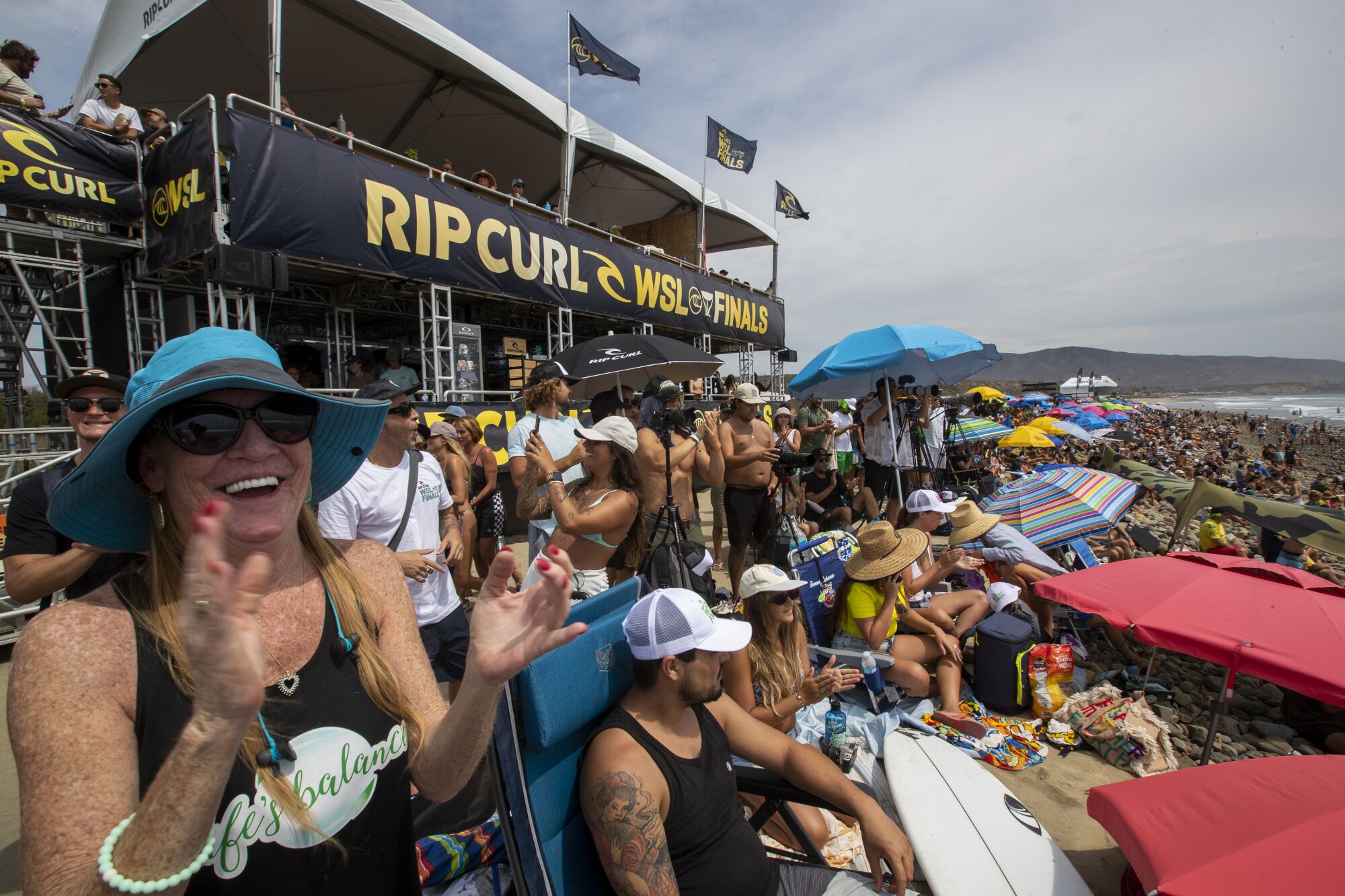 Hundreds of fans line the beach to watch the WSL Finals at Lower Trestles in San Clemente.