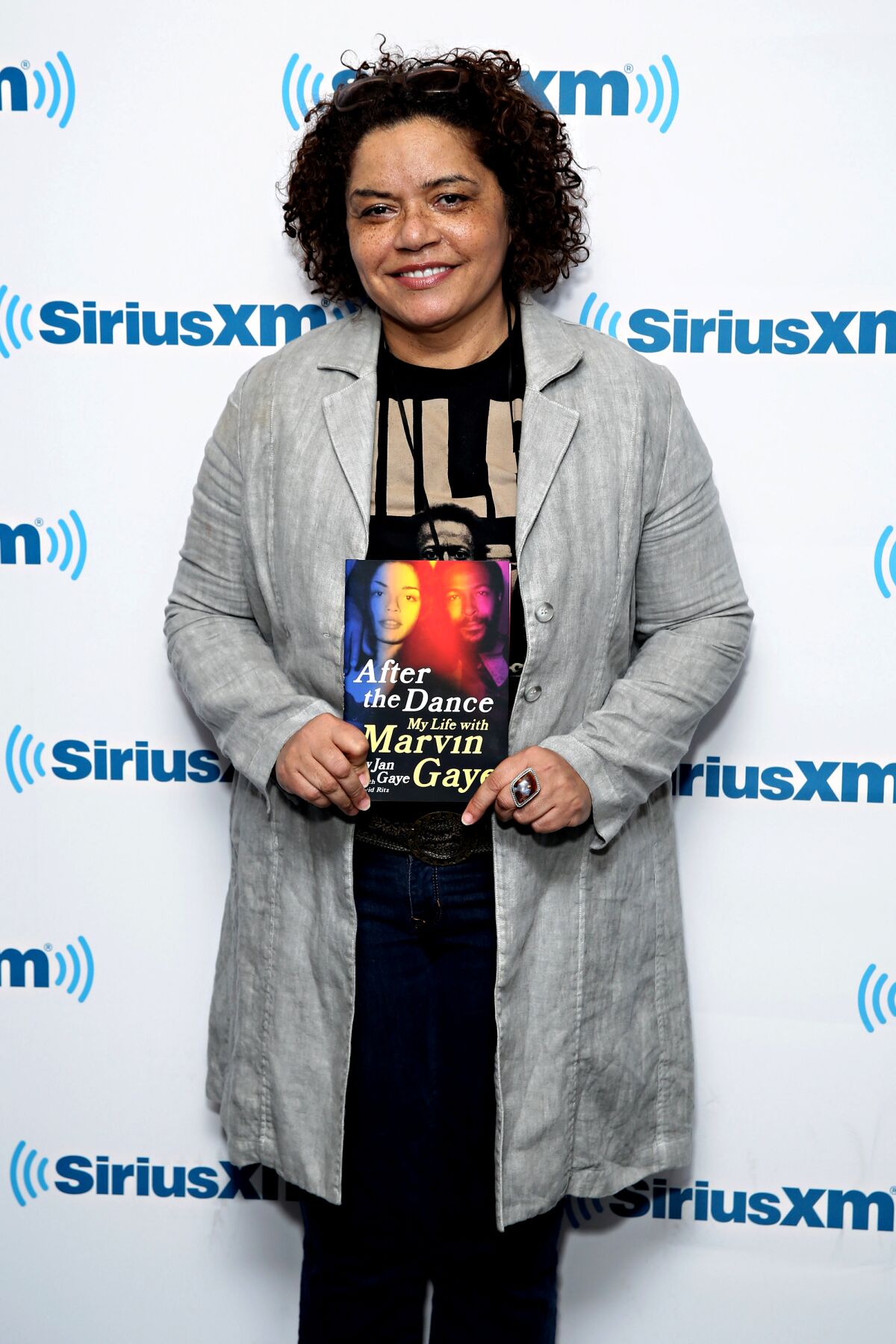 A woman holds a copy of her autobiography