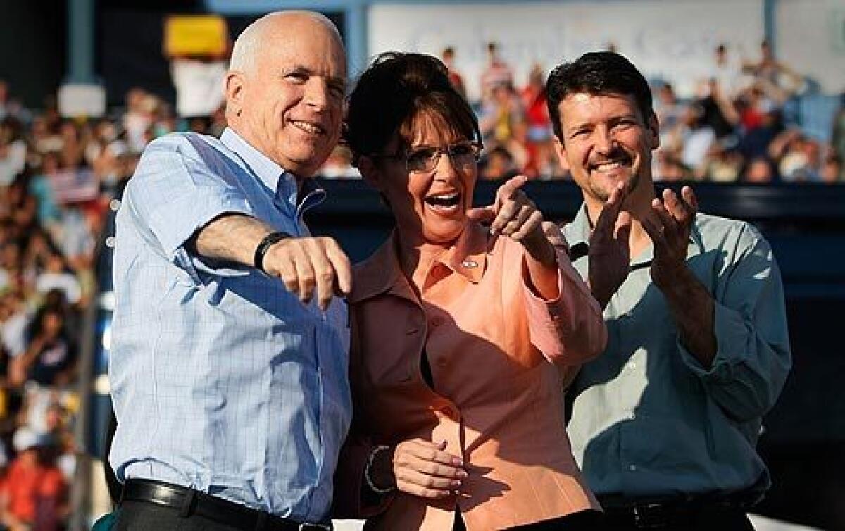 Republican presidential candidate Sen. John McCain of Arizona, left, his newly minted running mate, Alaska Gov. Sarah Palin, and her husband, Todd, greet supporters during a campaign event at Consol Energy Park in Washington, Pa. More photos >>>