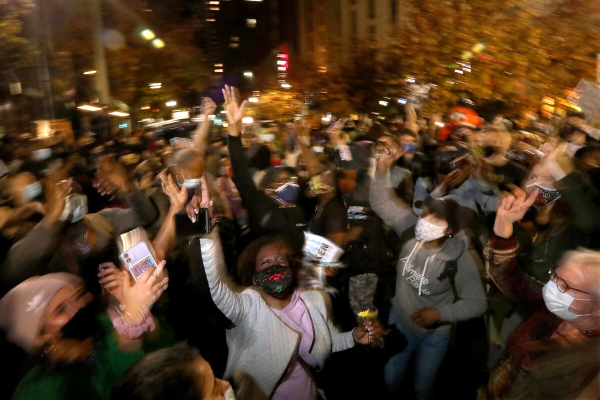 A pro-Biden crowd dances at the intersection of Third and Arch streets in Philadelphia.