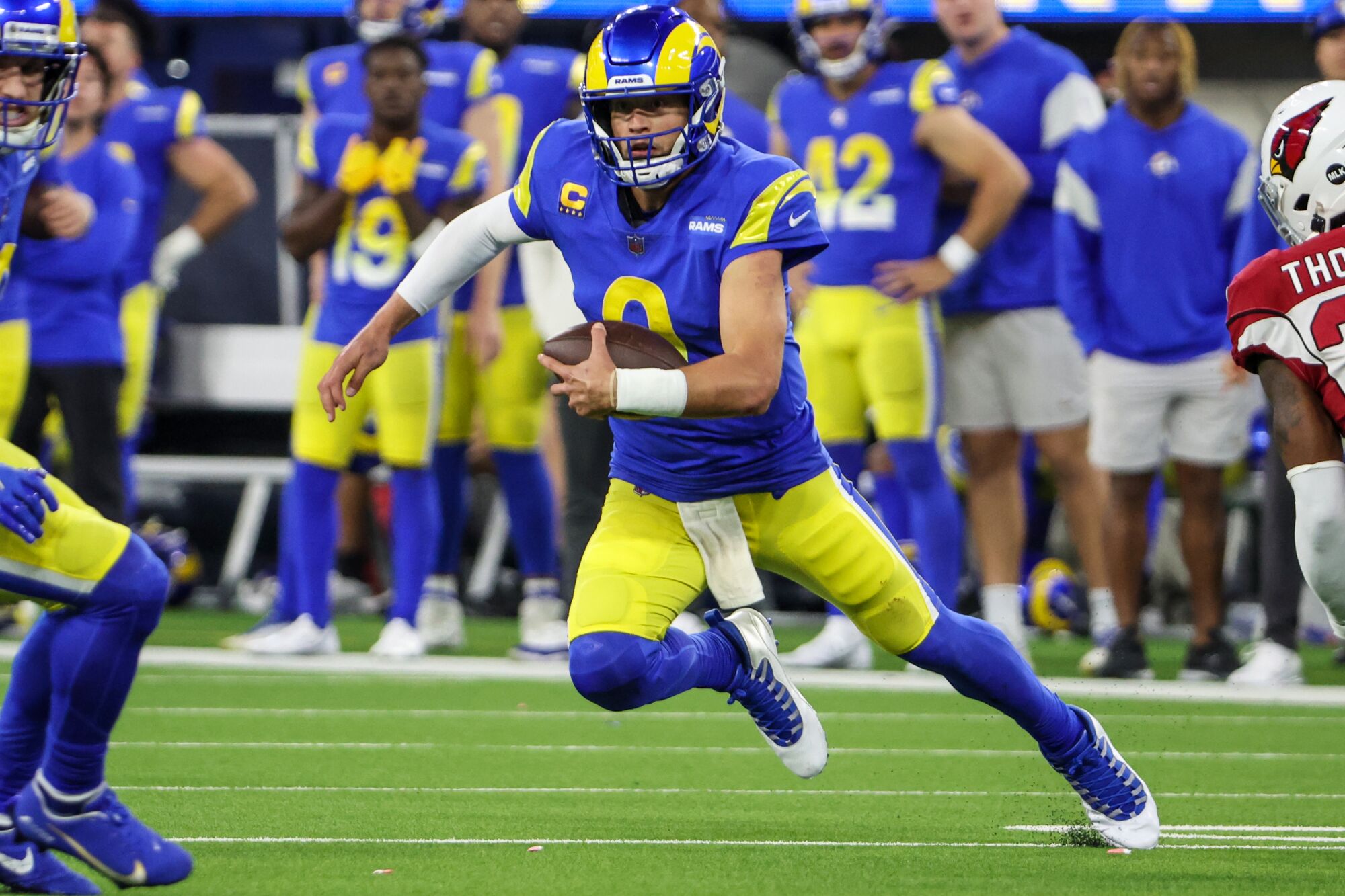 Rams quarterback Matthew Stafford scrambles during a wild-card playoff win over the Arizona Cardinals.