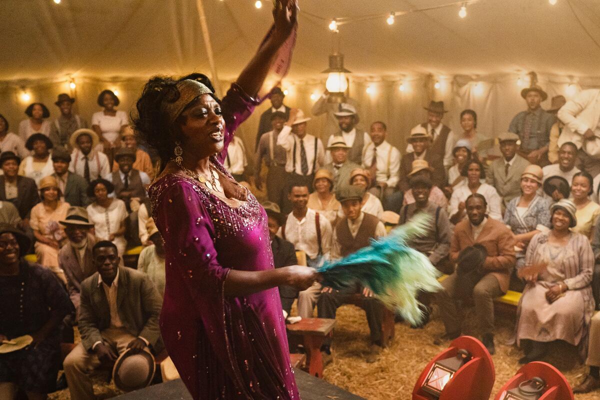 Viola Davis as Ma Rainey in front of a crowd of people