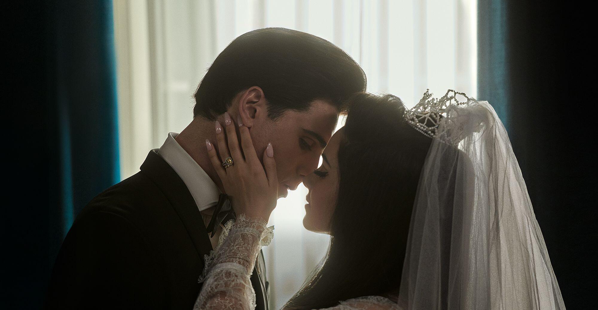 Jacob Elordi and Cailee Spaeny kiss as Elvis and Priscilla Presley on their wedding day in the movie "Priscilla."