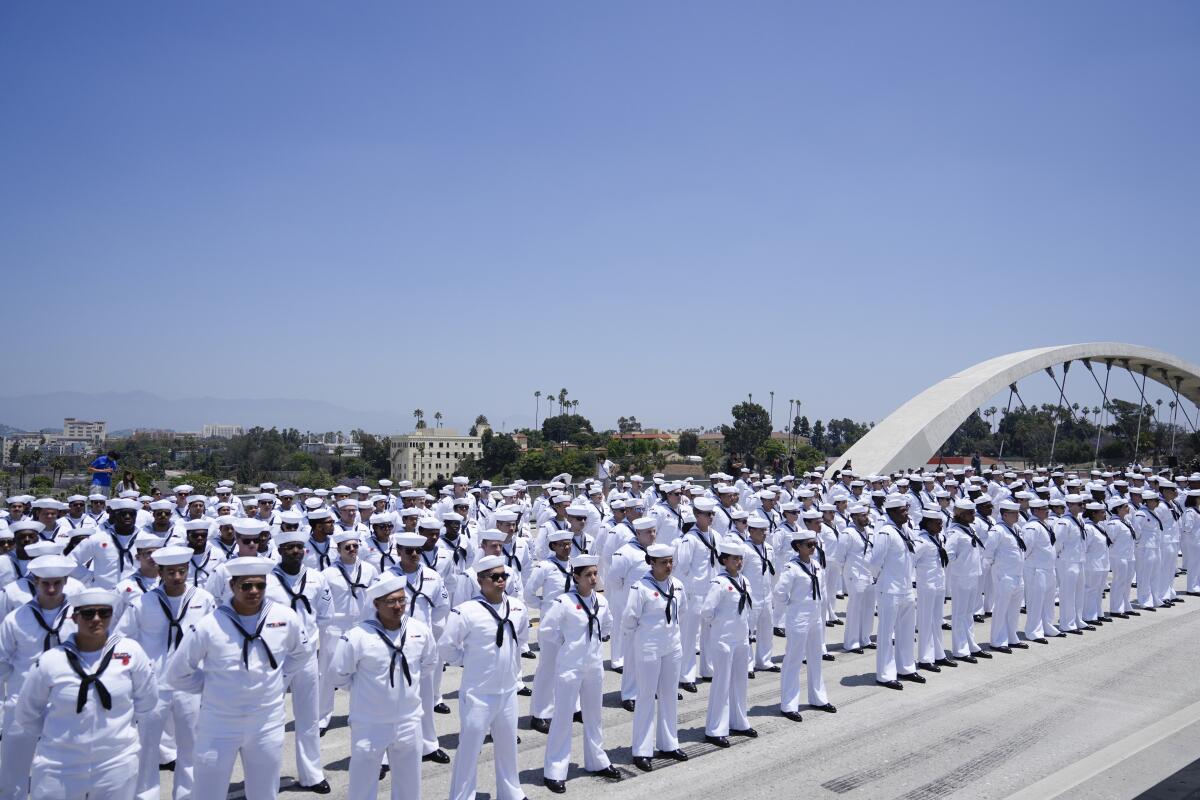 Rows of sailors standing in the vast expanse.