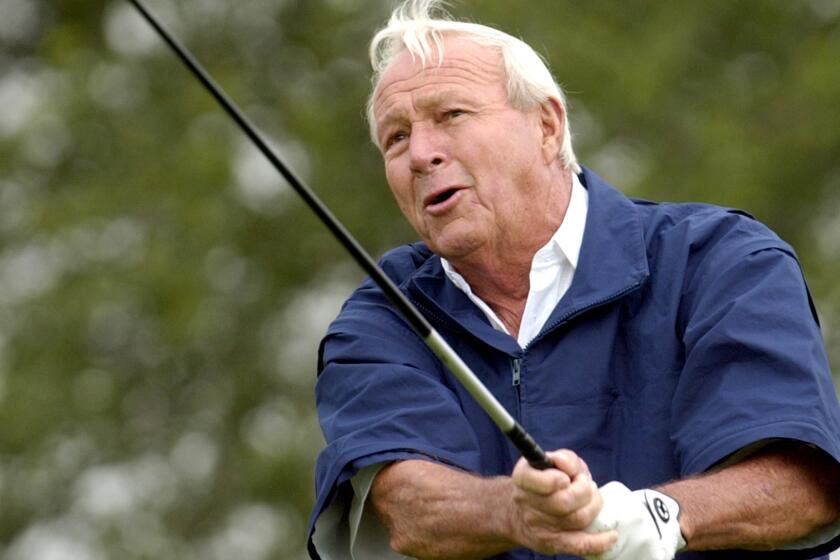 Arnold Palmer tees off during the Senior PGA Championship at Valhalla Golf Club in 2004.