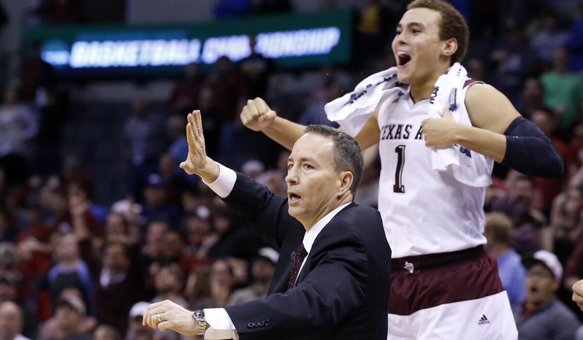 Texas A&M head coach Billy Kennedy gestures as forward DJ Hogg (1) cheers behind him in the second half against Northern Iowa in the NCAA Tournament Sunday