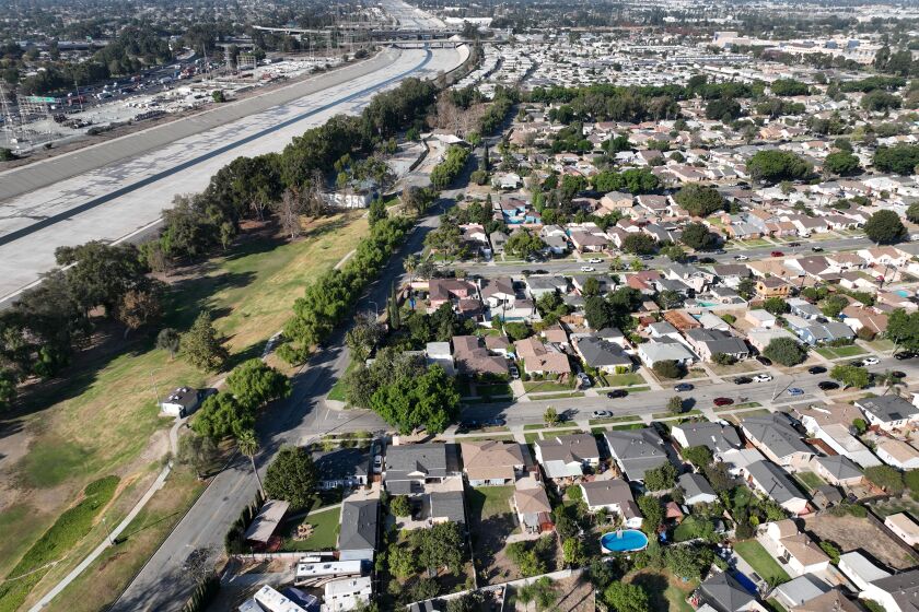 Long Beach, CA - October 05: An aerial view of the Los Angeles River west of DeForest Park in North Long Beach and the neighborhood east of the river and park in Long Beach, Wednesday, Oct. 5, 2022. A new UCI study warns that a major food would hit Los Angeles County's low-lying Black communities disproportionately hard. Working-class neighborhoods adjacent to the Los Angeles River in North Long Beach, for example, would be under six feet of water. (Allen J. Schaben / Los Angeles Times)