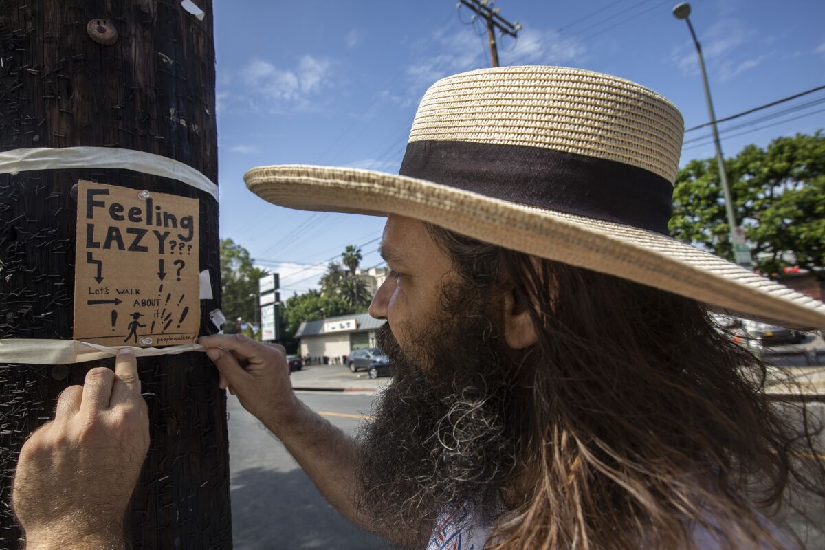 Chuck McCarthy's handmade signs drew attention to his burgeoning people-walking business.