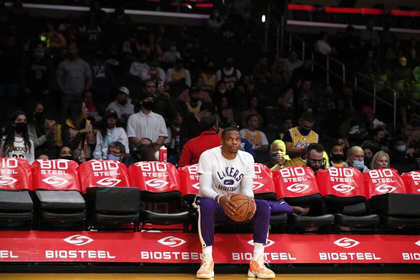 Lakers guard Russell Westbrook sits alone on the bench before taking on the Houston Rockets at Staples Center on Nov. 2, 2021