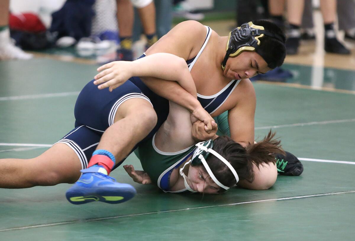 Newport Harbor's Max Hernandez, on top, battles Costa Mesa's Breanne Raya in the 195-pound match of the Newport-Mesa District championships on Wednesday at Costa Mesa High.