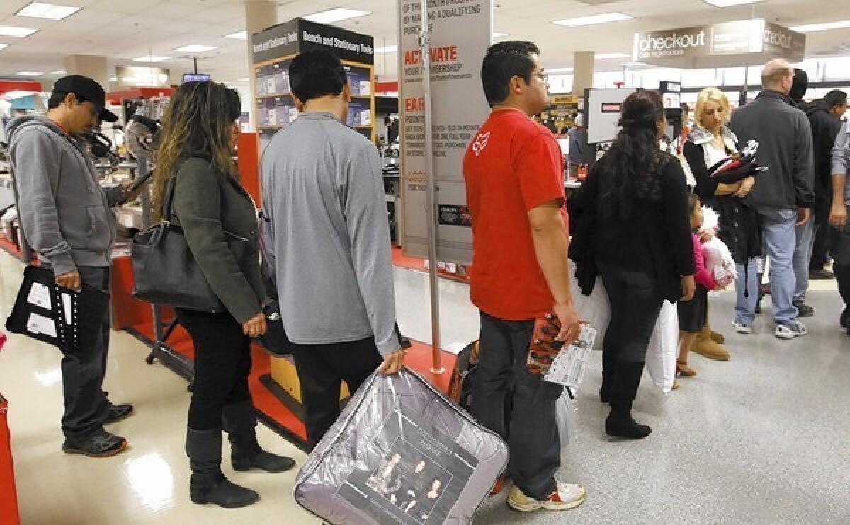 Shoppers at South Coast Plaza in Costa Mesa round the bend in the checkout line at Sears on Black Friday afternoon.