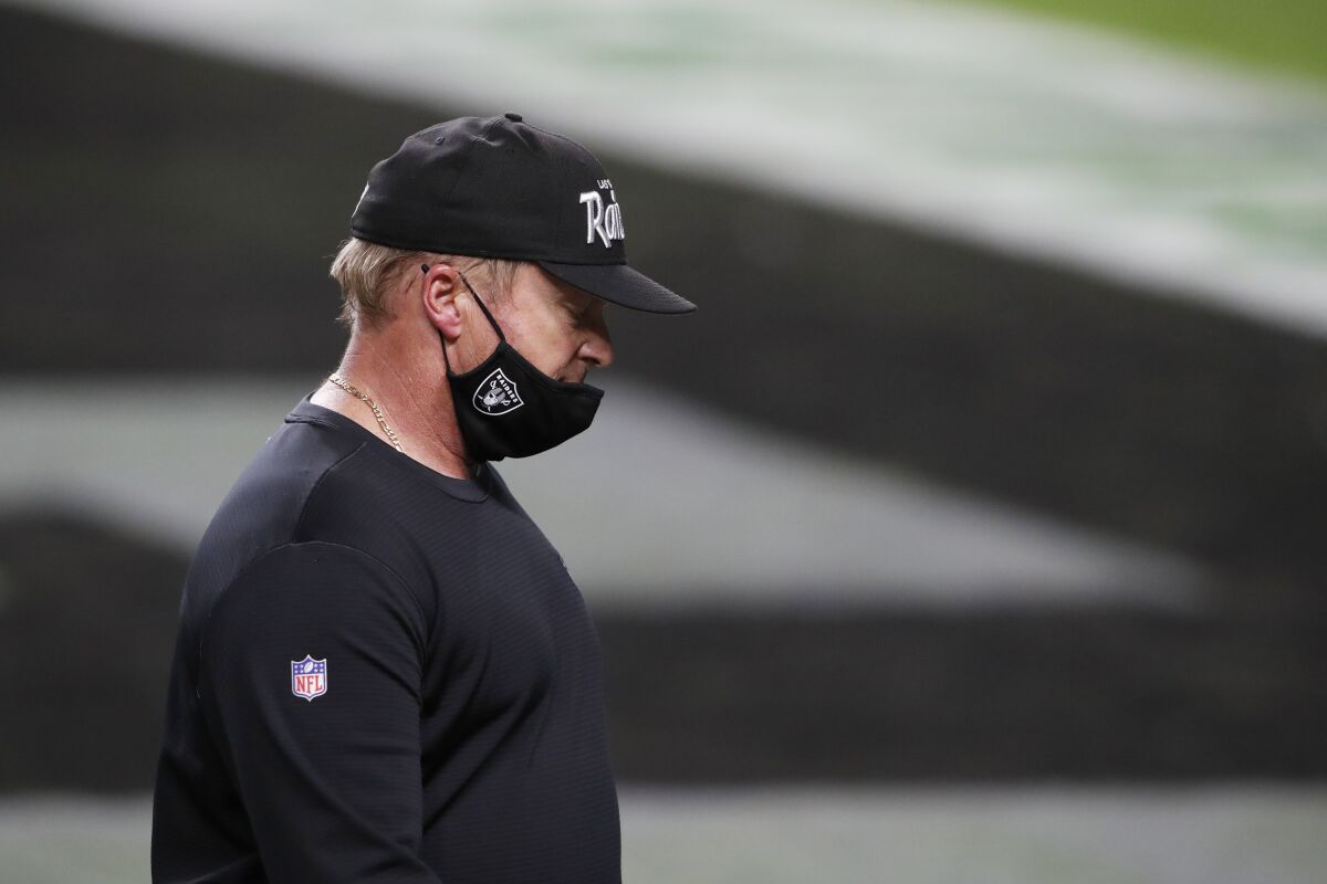 Las Vegas Raiders coach Jon Gruden walks off the field after losing to the Miami Dolphins on Dec. 26, 2020.