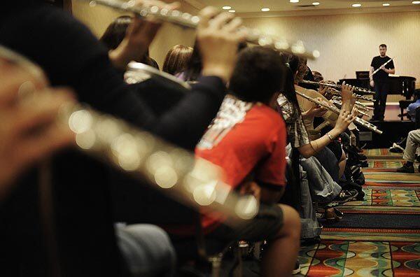 Greg Pattillo listens to the music of participants after teaching basic instruction on how to beatbox during the National Flute Convention in Anaheim on Aug. 14.