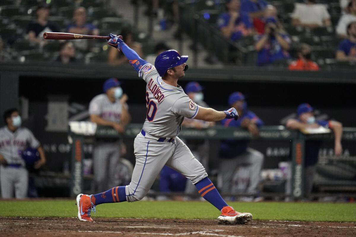 New York Mets designated hitter Pete Alonso watches his ball while hitting a solo home run off Baltimore Orioles relief pitcher Travis Lakins Sr., during the ninth inning of a baseball game, Tuesday, June 8, 2021, in Baltimore. The Orioles won 10-3. (AP Photo/Julio Cortez)