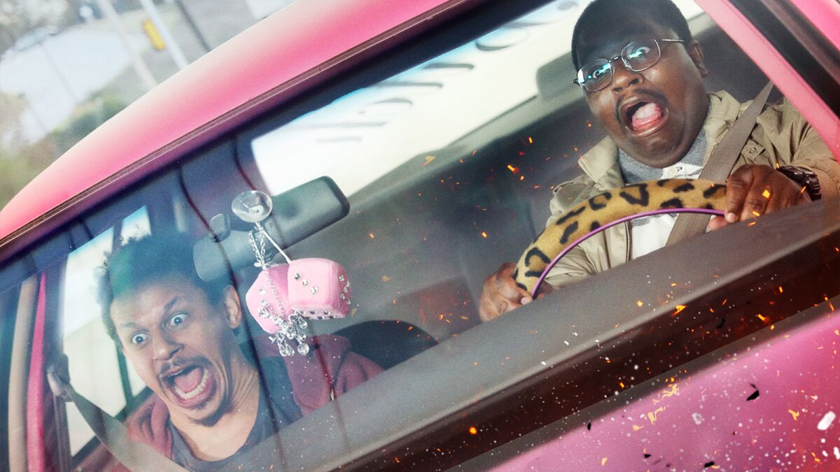 Eric Andre, left, and Lil Rel Howery scream in the front seat of a car