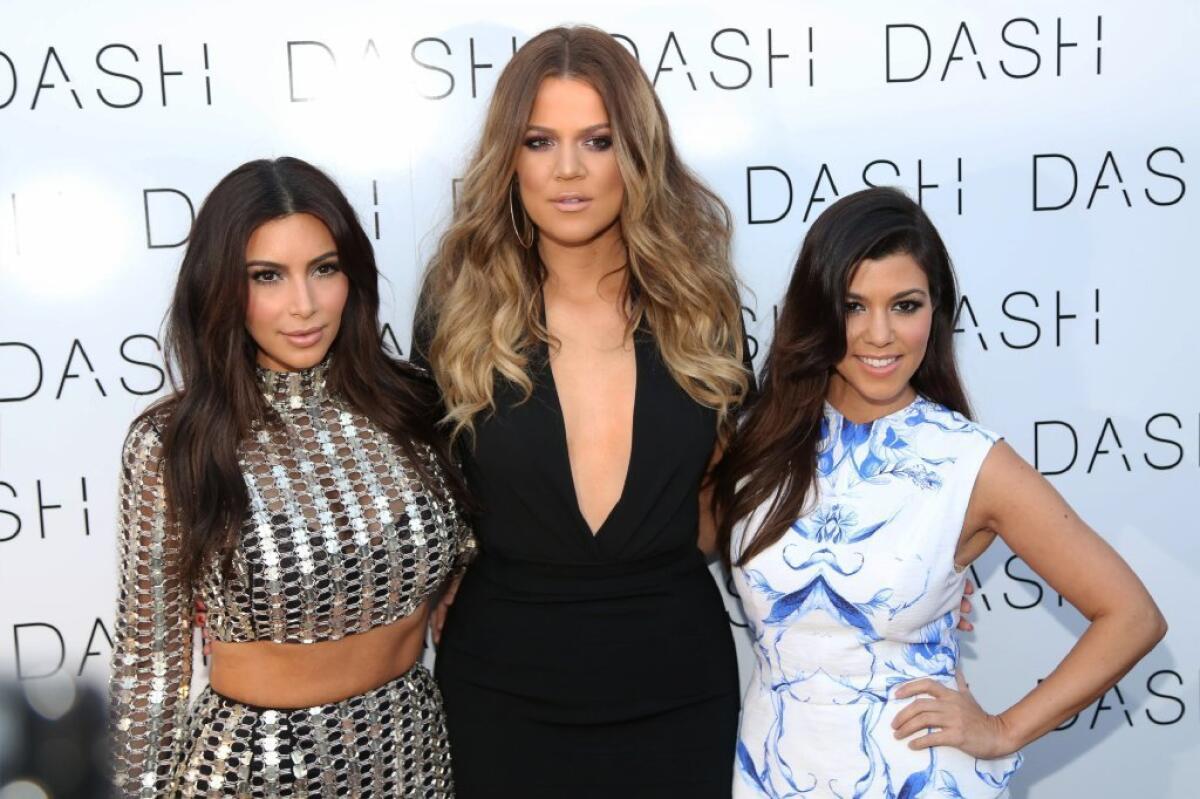 From left, Kim Kardashian, Khloe Kardashian and Kourtney Kardashian celebrate the grand opening of their store DASH Miami Beach.