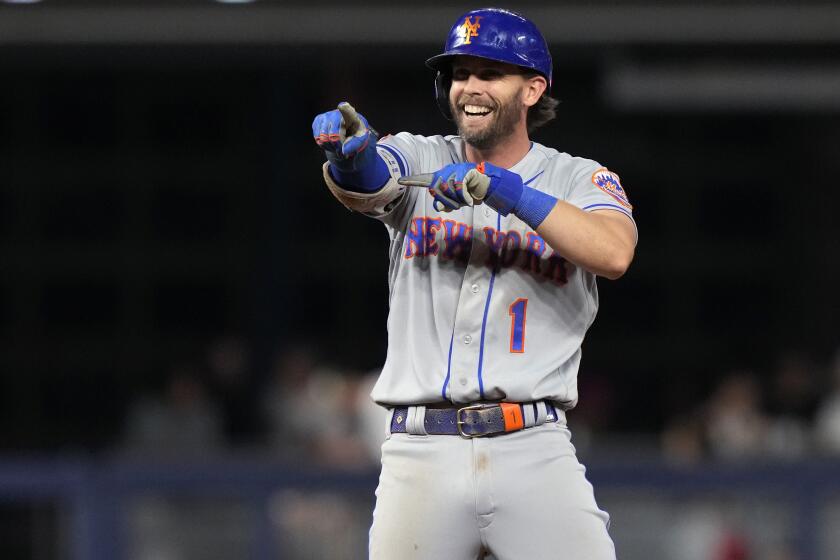 New York Mets' Jeff McNeil reacts after hitting a double during the ninth inning of the team's baseball game against the Miami Marlins, Tuesday, Sept. 19, 2023, in Miami. (AP Photo/Lynne Sladky)