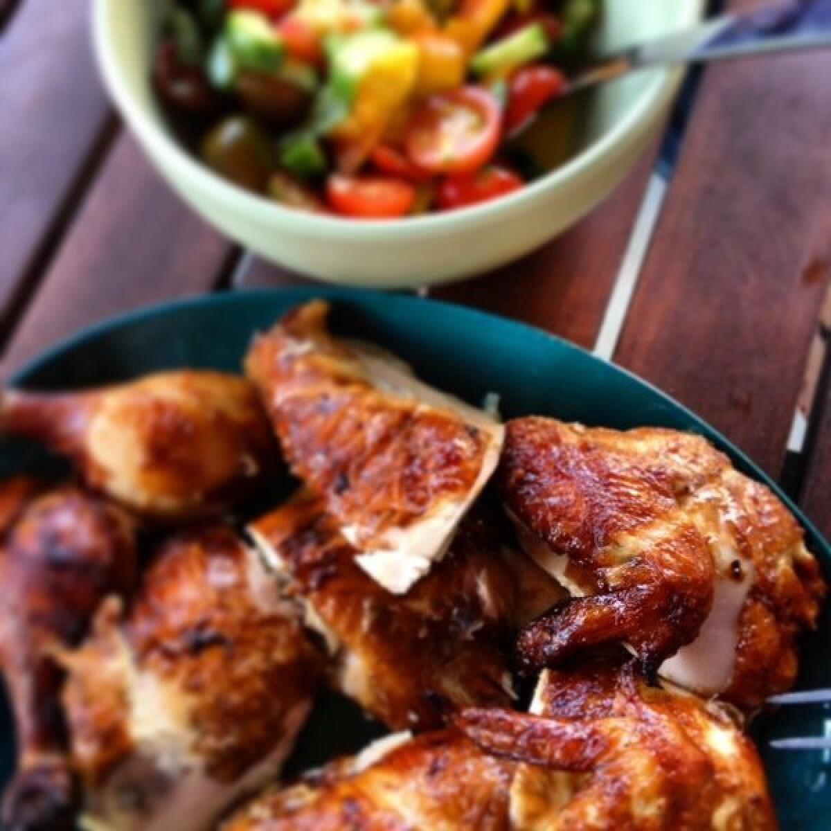 Smoked chicken from the rotisserie, served with a tomato salad.
