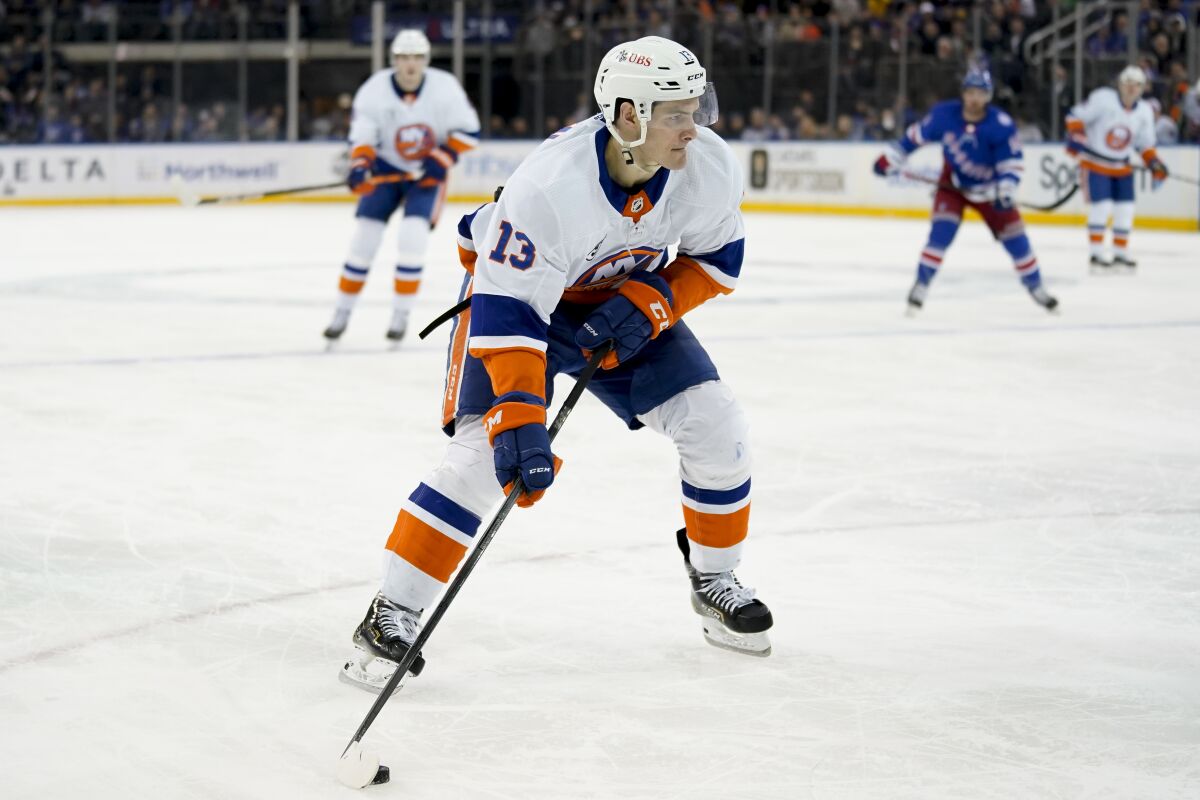 New York Islanders center Mathew Barzal (13) eyes a shot on goal during the first period of an NHL hockey game against the New York Rangers, Friday, April 1, 2022, in New York. (AP Photo/John Minchillo)