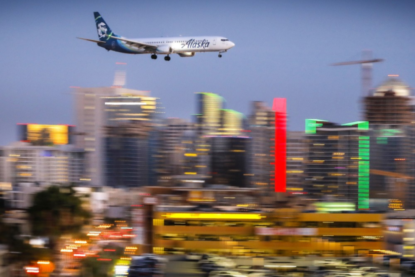 An Alaska Airlines Boeing 737 passes downtown San Diego moments before arriving at San Diego International Airport, May 7, 2018.