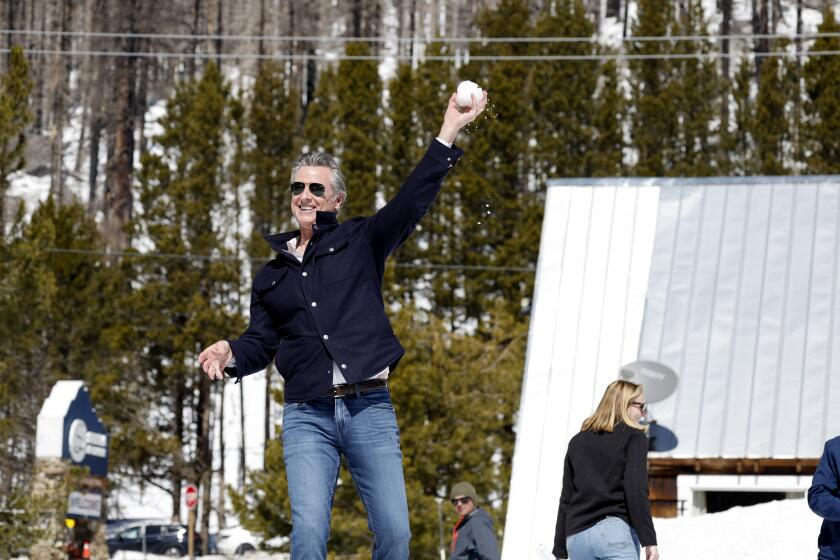 In this image provided by the California Department of Water Resources, California Gov. Gavin Newsom tosses a snowball after the California Department of Water Resources Snow Surveys and Water Supply Forecasting Unit conducted the fourth media snow survey of the 2024 season at Phillips Station in El Dorado County, Calif., on Tuesday, April 2, 2024. (Fred Greaves/California Department of Water Resources via AP)