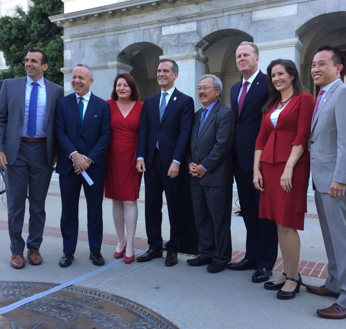 Los Angeles Mayor Eric Garcetti, center, stands with mayors of other large California cities and state lawmakers outside the Capitol