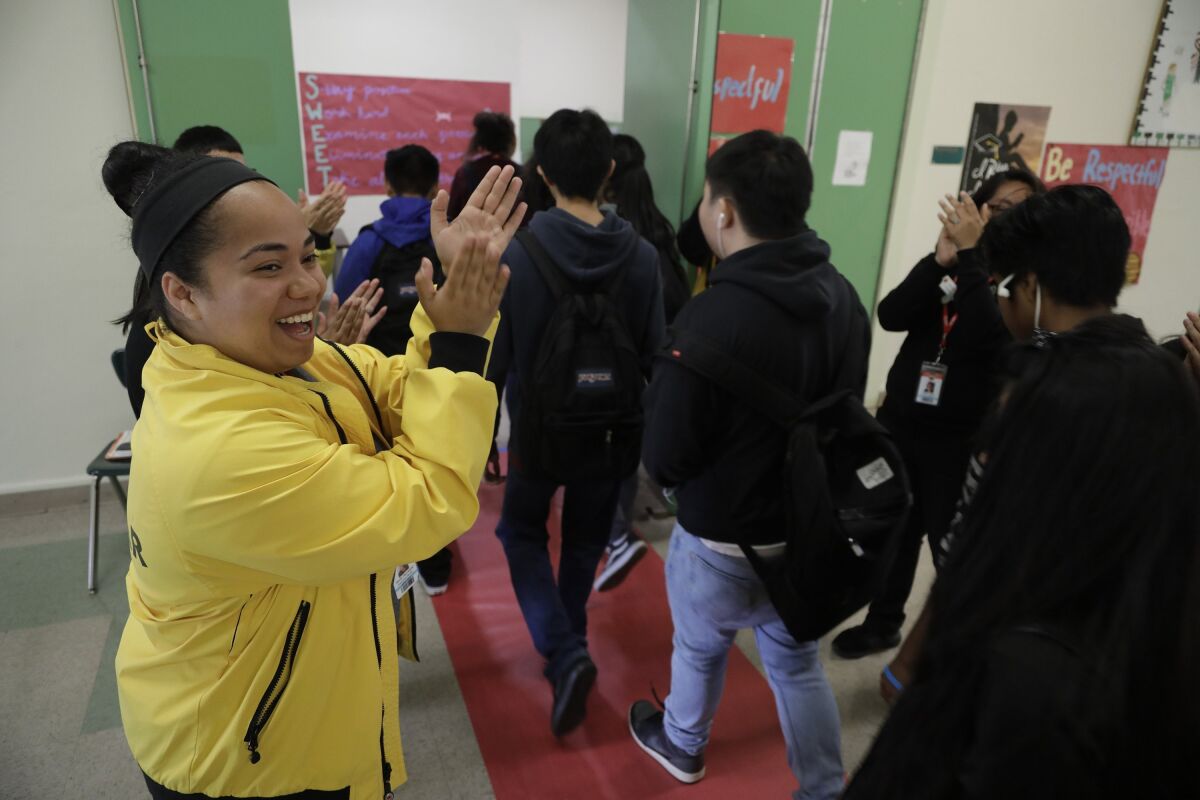 Students at Belmont High in Los Angeles are cheered on as they prepare to take the SAT exam.