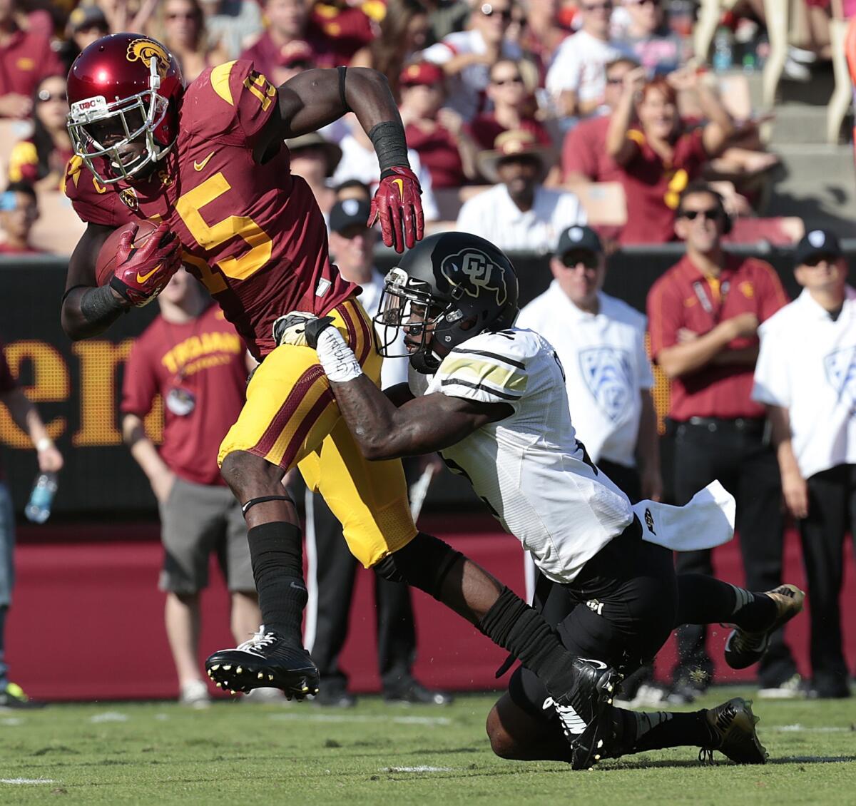 USC receiver Nelson Agholor drags Colorado defensive back Ken Crawley into the end zone for an 18-yard touchdown during the first quarter Saturday at the Coliseum.