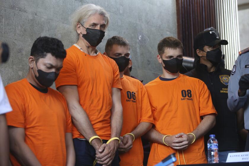 Suspects line up during a news conference at a villa in Canggu, Bali, Indonesia on Monday, May 13, 2024. Indonesian police raided what they said was a major drug lab hidden in a villa on the resort island of Bali, and arrested four people. (AP Photo/Firdia Lisnawati)