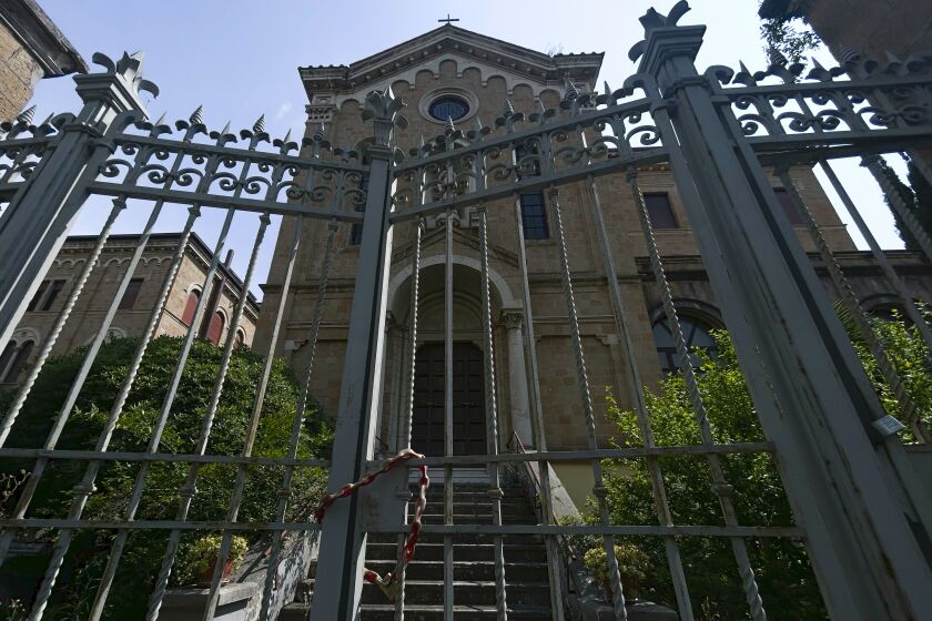 A view of a former monastery, in Rome, Monday, May 29, 2023, situated on a quiet residential street. It once sheltered Jews fleeing deportation in World War II. Purchased by the Vatican in 2021 as a dormitory for foreign nuns studying at Rome’s pontifical universities, the building now stands empty, a collateral victim of the latest financial scandal to hit the Holy See. (AP Photo/Alessandra Tarantino)