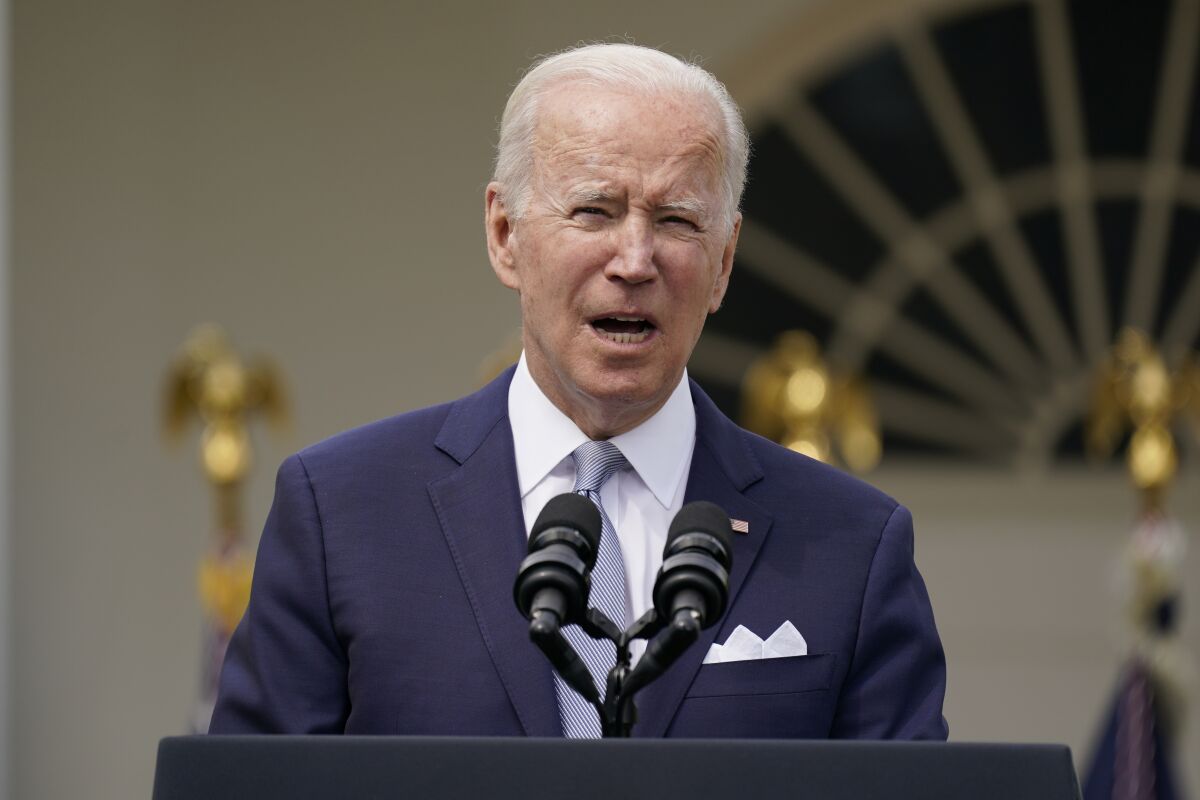 President Biden speaks in front of two microphones