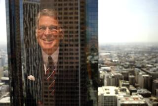 Nelson C. Rising, President and CEO of Maguire Properties, is reflected in a window in the company's offices 