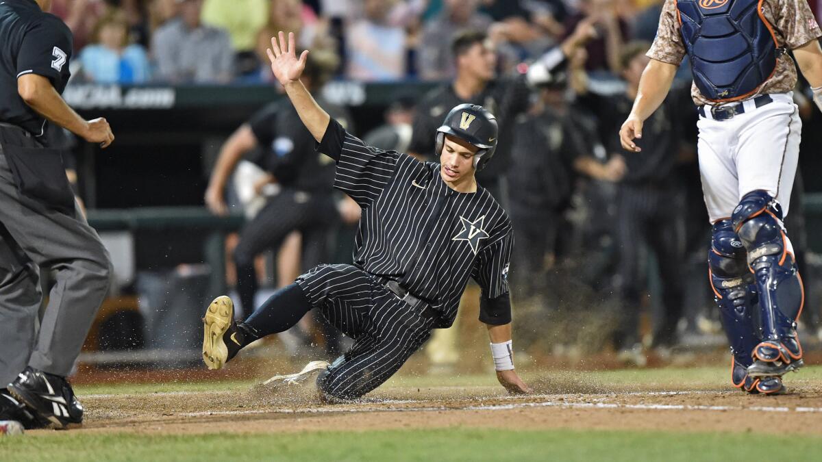 Vanderbilt's Bryan Reynolds scores a run during the sixth inning of Game 1 of the College World Series against Virginia on Monday.