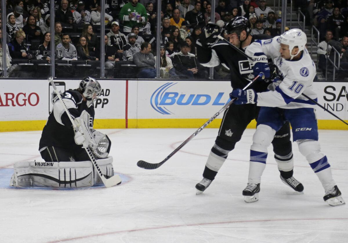 Kings goalie Jonathan Quick covers up the puck after stopping a shot from Tampa Bay forward Brenden Morrow during the second period of L.A.'s 3-2 win over the Lightning at Staples Center.