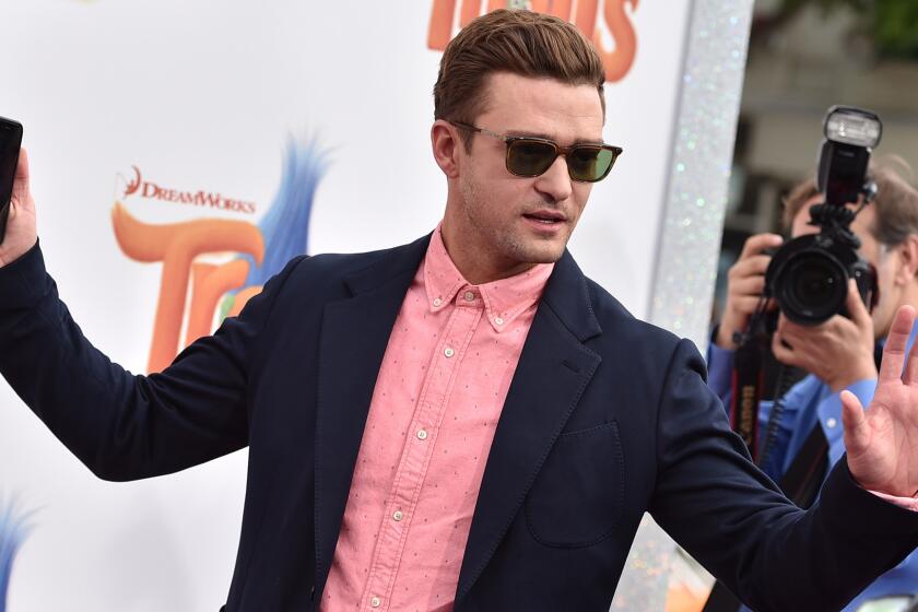 Phone in hand, Justin Timberlake arrives at the premiere of "Trolls" in Los Angeles on Sunday.