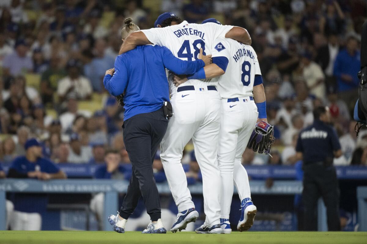 Dodgers relief pitcher Brusdar Graterol is helped off the field after sustaining a Grade 3 hamstring strain.