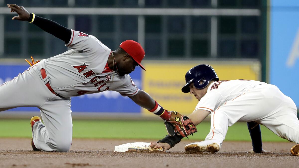 Angels second baseman Brandon Phillips applies a late tag as Houston's Alex Bregman steals second base during the first inning Saturday.
